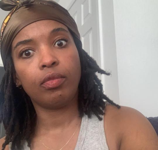 Image of Nana, who is wearing a headscarf and a small gold necklace